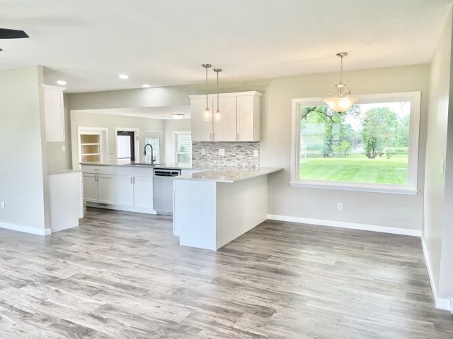 1028 Franklin Grove Road Dixon, IL 61021 - Photo 13 of 48 a view of kitchen with granite countertop cabinets and wooden floor
