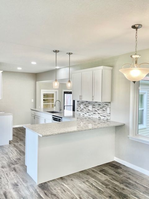 1028 Franklin Grove Road Dixon, IL 61021 - Photo 14 of 48 a kitchen with kitchen island granite countertop a white cabinets and a stove