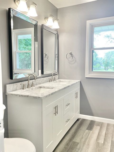 1028 Franklin Grove Road Dixon, IL 61021 - Photo 18 of 48 a bathroom with a granite countertop sink a toilet and a window