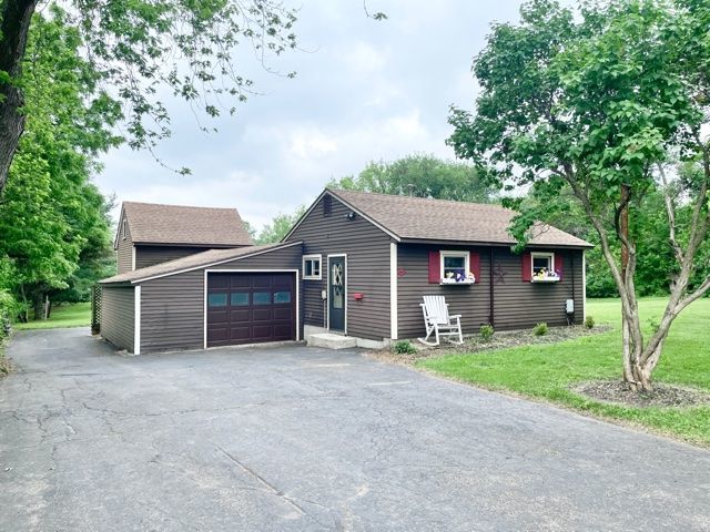 1028 Franklin Grove Road Dixon, IL 61021 - Photo 31 of 48 a front view of a house with a yard and garage