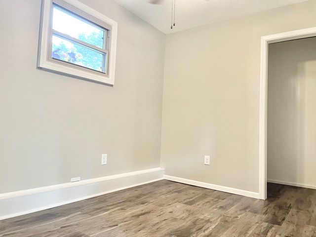 1028 Franklin Grove Road Dixon, IL 61021 - Photo 42 of 48 an empty room with wooden floor and windows