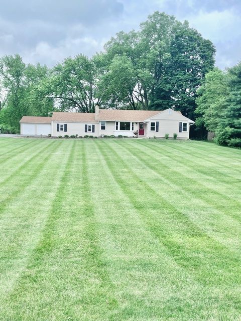 1028 Franklin Grove Road Dixon, IL 61021 - Photo 8 of 48 a front view of a house with a garden