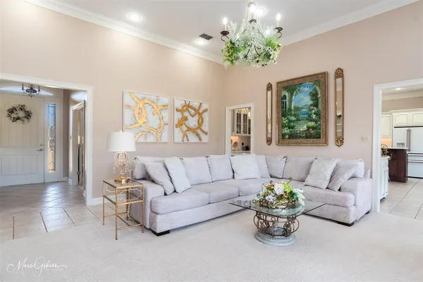 a living room with furniture and a chandelier