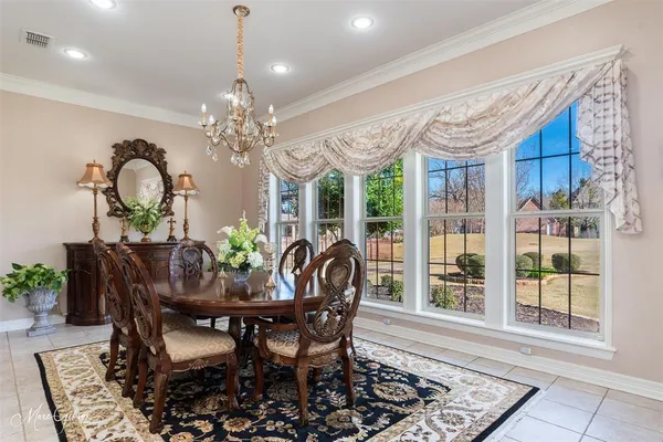 a view of a dining room with furniture and chandelier