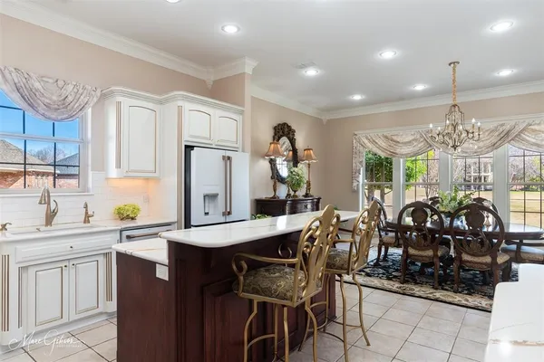 a kitchen with stainless steel appliances granite countertop a sink and a refrigerator