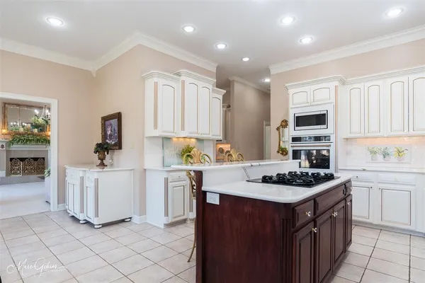 a kitchen with cabinets and a stove top oven