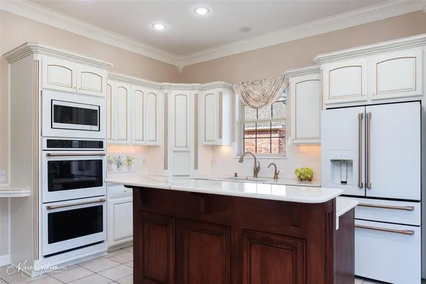 a kitchen with stainless steel appliances a stove sink and refrigerator