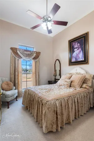 a bedroom with a bed and a large window