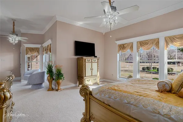 a bedroom with a bed and a flat screen television