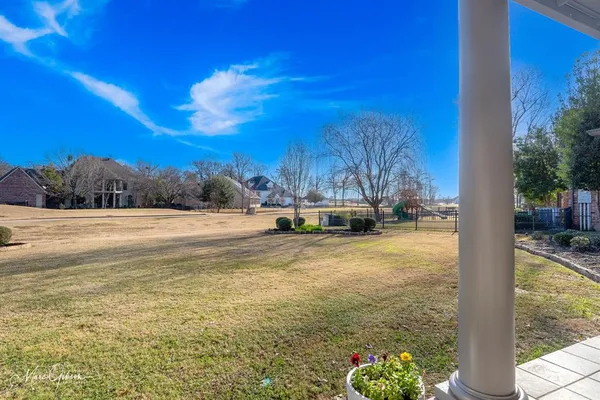 a view of yard with swimming pool and trees