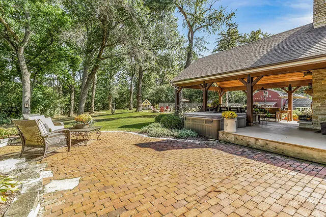 a view of a house with backyard and sitting area