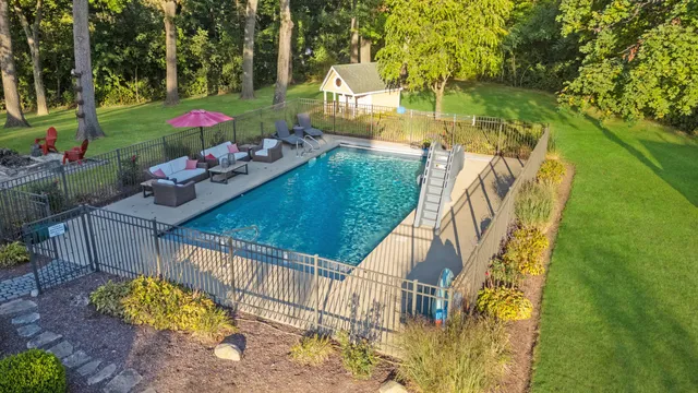 a view of a house with backyard and garden