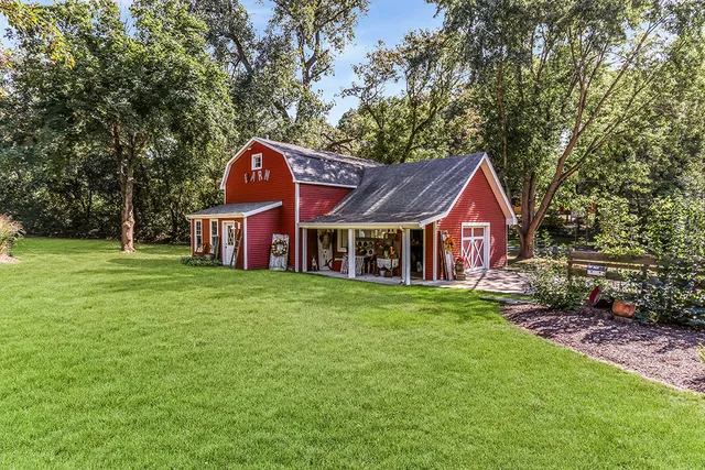 a swimming pool view with a seating space and a garden