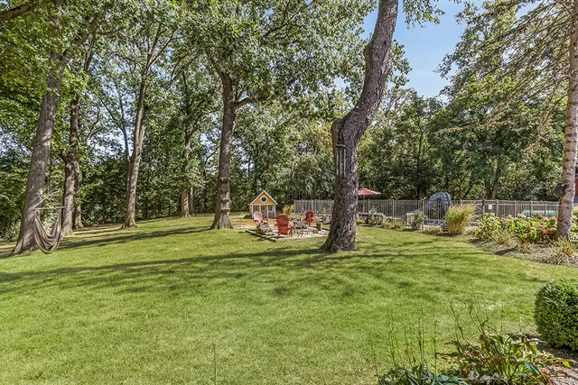 a living room with furniture a fireplace and a table