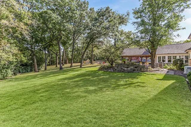 a living room with furniture and a dining table with wooden floor