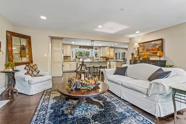 a view of a dining room with furniture a chandelier and wooden floor