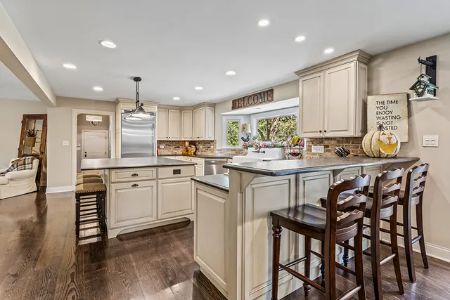 a bedroom with a bed a couch and a large window