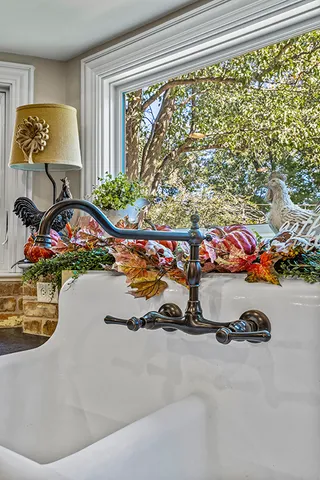 a bedroom with natural light and a large window