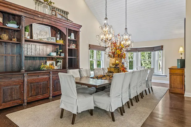 a living room with furniture a chandelier and a fireplace