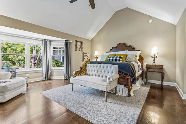 a bedroom with a bed and a chandelier