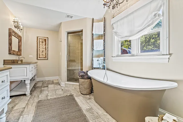 a bathroom with a sink a mirror and a shower