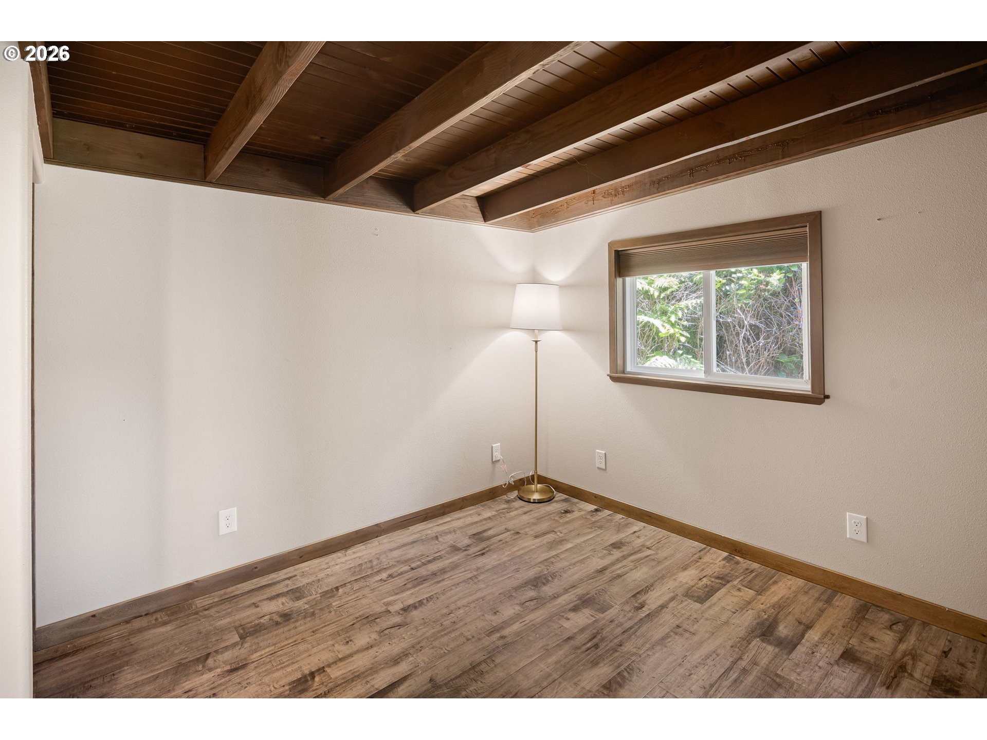 88481 1st Avenue Florence, OR 97439 - Photo 25 of 43 a view of an empty room with wooden floor and a window