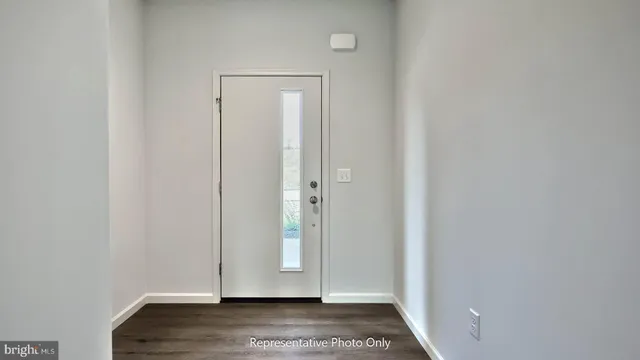 a view of front door with wooden floor