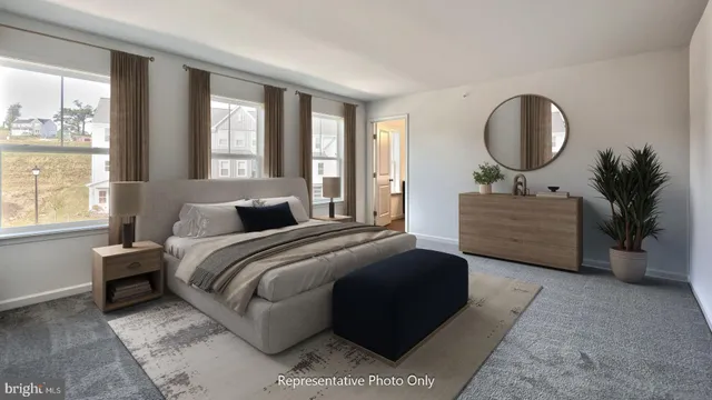 a bedroom with a large bed and a potted plant