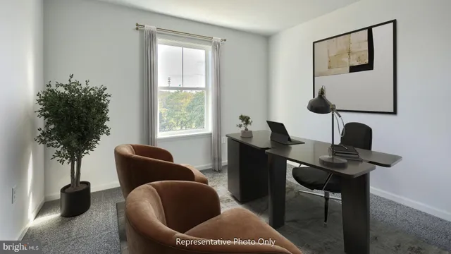 a work room with furniture and a potted plant