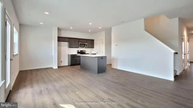 a view of kitchen with wooden floor and electronic appliances