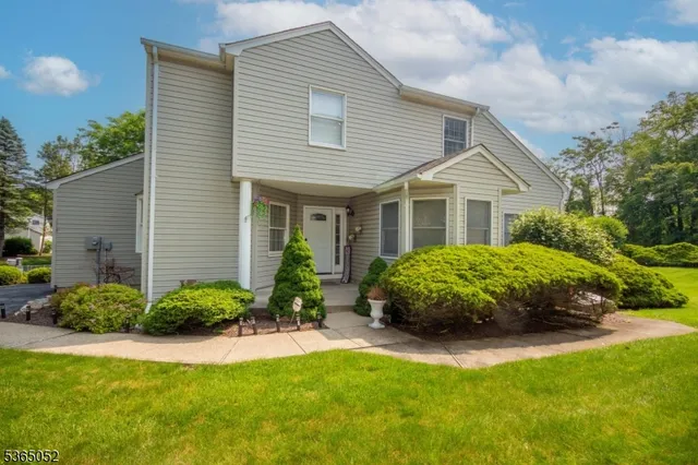 a view of a house with a garden and plants