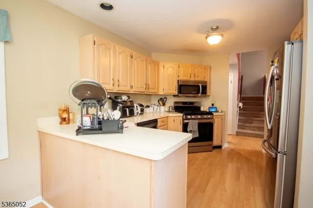 a kitchen with a refrigerator stove and a sink