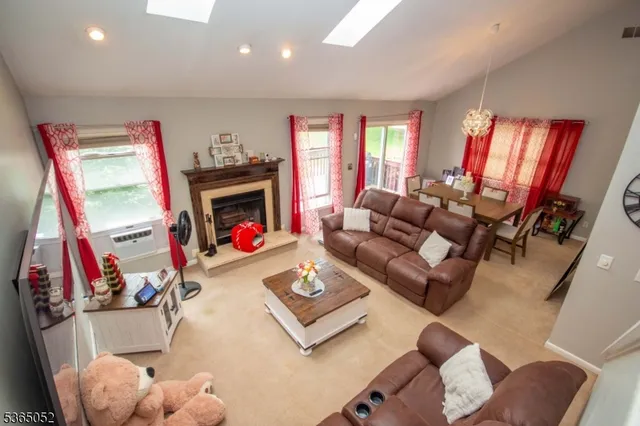 a living room with furniture fireplace and a large window