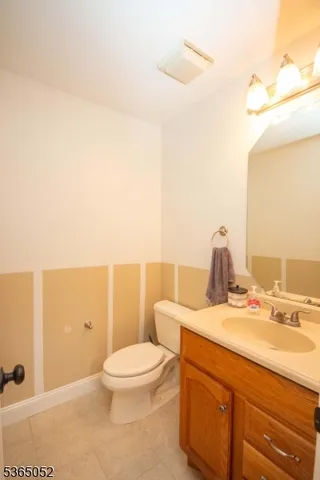 a bathroom with a sink a toilet and vanity