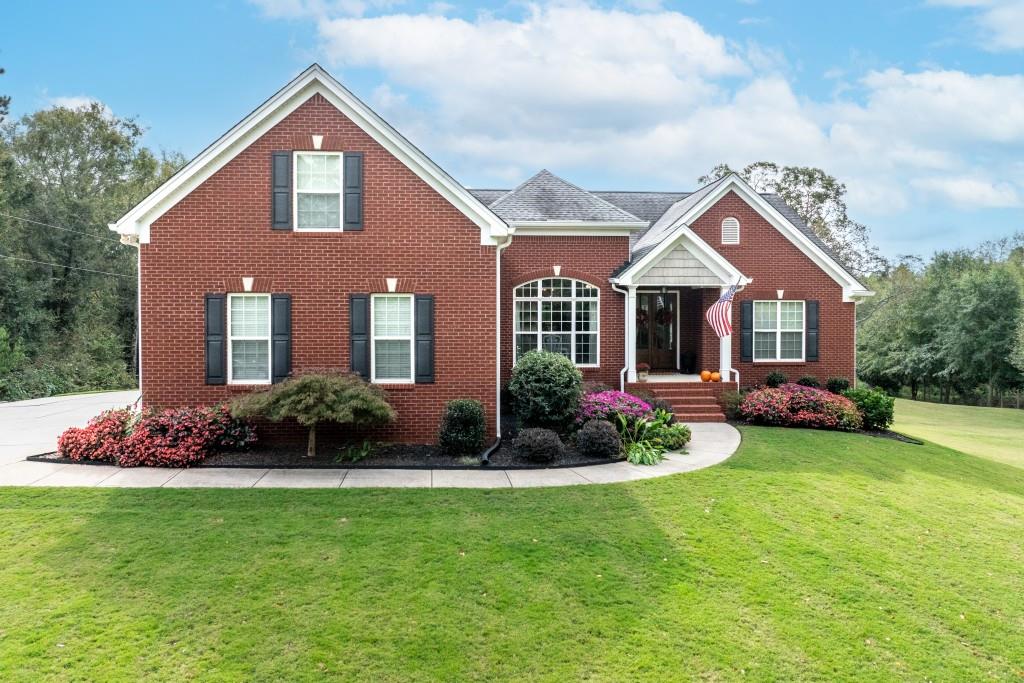 a front view of a house with a garden