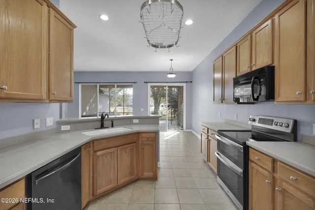 a kitchen with stainless steel appliances a sink stove and cabinets