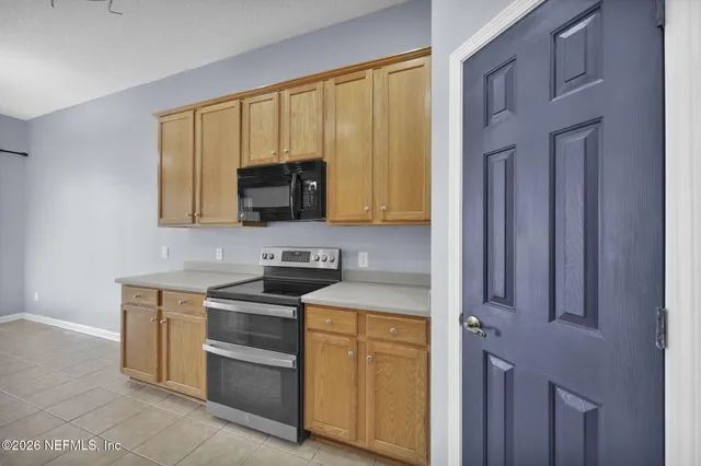 a kitchen with a stove microwave and sink