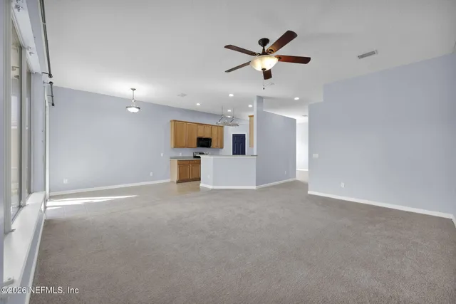a view of a big room with a kitchen