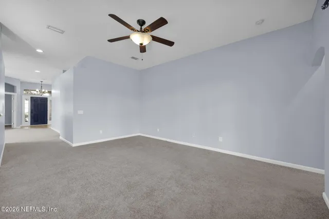 an empty room with a empty space and a ceiling fan