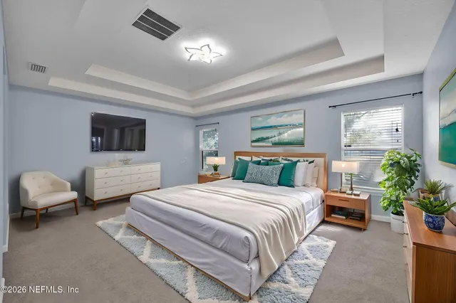 a bedroom with a bed and a couch