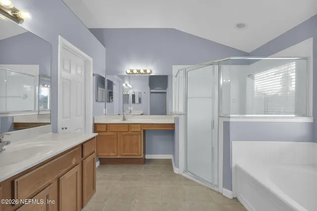 a large bathroom with a large tub shower and sink
