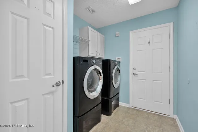 a view of storage and utility room with washer and dryer