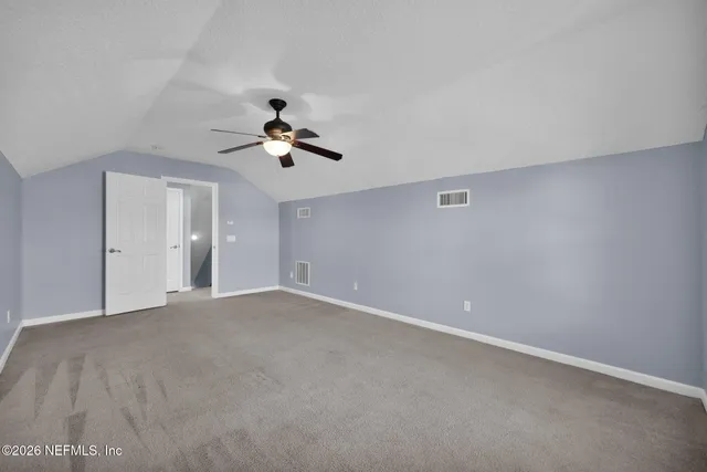 a view of empty room with ceiling fan