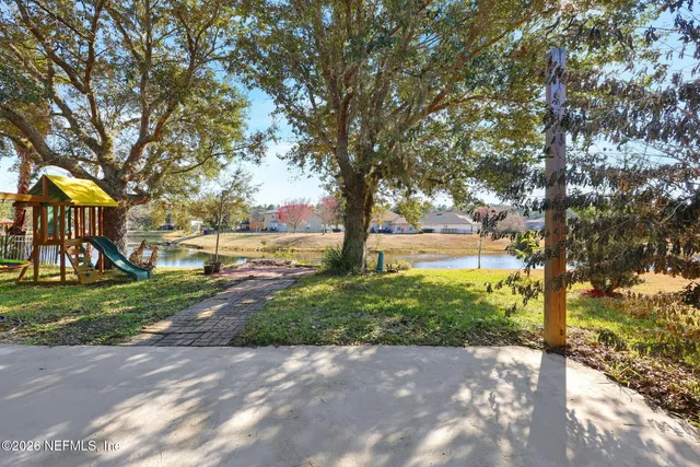 a view of a street with a tree in the background