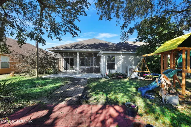 a front view of a house with yard patio and green space