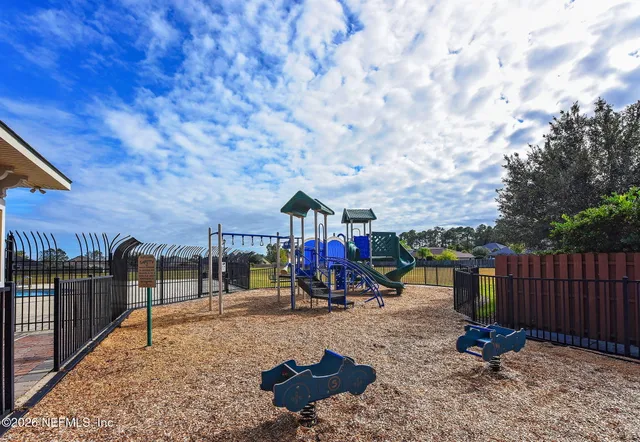a view of a park with iron fence