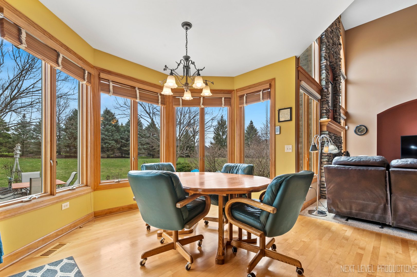 5370 Old Reserve Road Oswego, IL 60543 - Photo 24 of 48 a dining room with furniture a chandelier and large windows