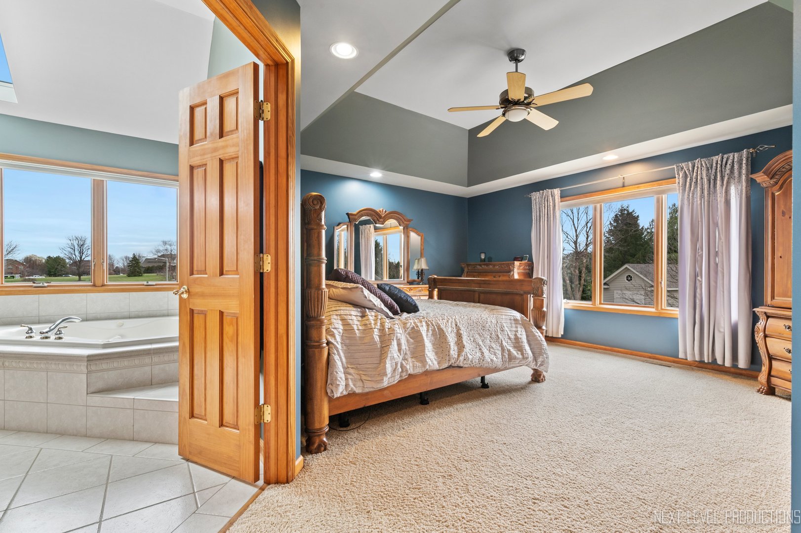 5370 Old Reserve Road Oswego, IL 60543 - Photo 29 of 48 a bedroom with a large bed and a chandelier