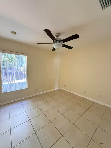 a view of a livingroom with a ceiling fan and window