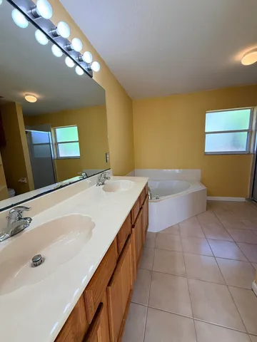 a bath room with a sink and a bath tub